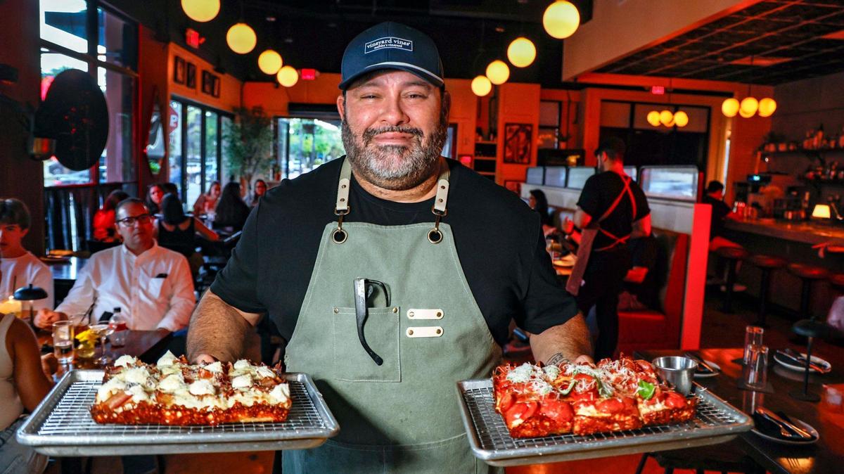 Owner Jorgie Ramos delivers pizzas to guests at Vice City Pizza in South Miami.