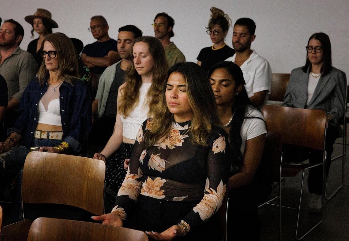 Yadira Diaz, PSYCA Miami Ambassador, center, participates with others in a meditation during a Psychedelics for Climate Action (PSYCA) launch event on Wednesday, Feb. 19, 2025, at Future of Cities Climate and Innovation HUB in Little Haiti, Miami. Many people talked about how psychedelics can have natural medical qualities. Others mentioned the importance of protecting the environment because psychedelics connect you to the environment around you.