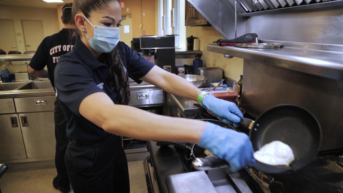 Melissa Winchester, a paramedic firefighter for nearly 20 years, makes breakfast at the start of the shift Friday at Fire Station #11 off Flagler Street. Before she leaves the firehouse, she showers, puts on fresh clothes and changes again once she gets home. For Mother’s Day, she won’t be seeing her Cuban mom or her 88-year-old grandmother, as she doesn’t want to risk exposing them to the coronavirus.