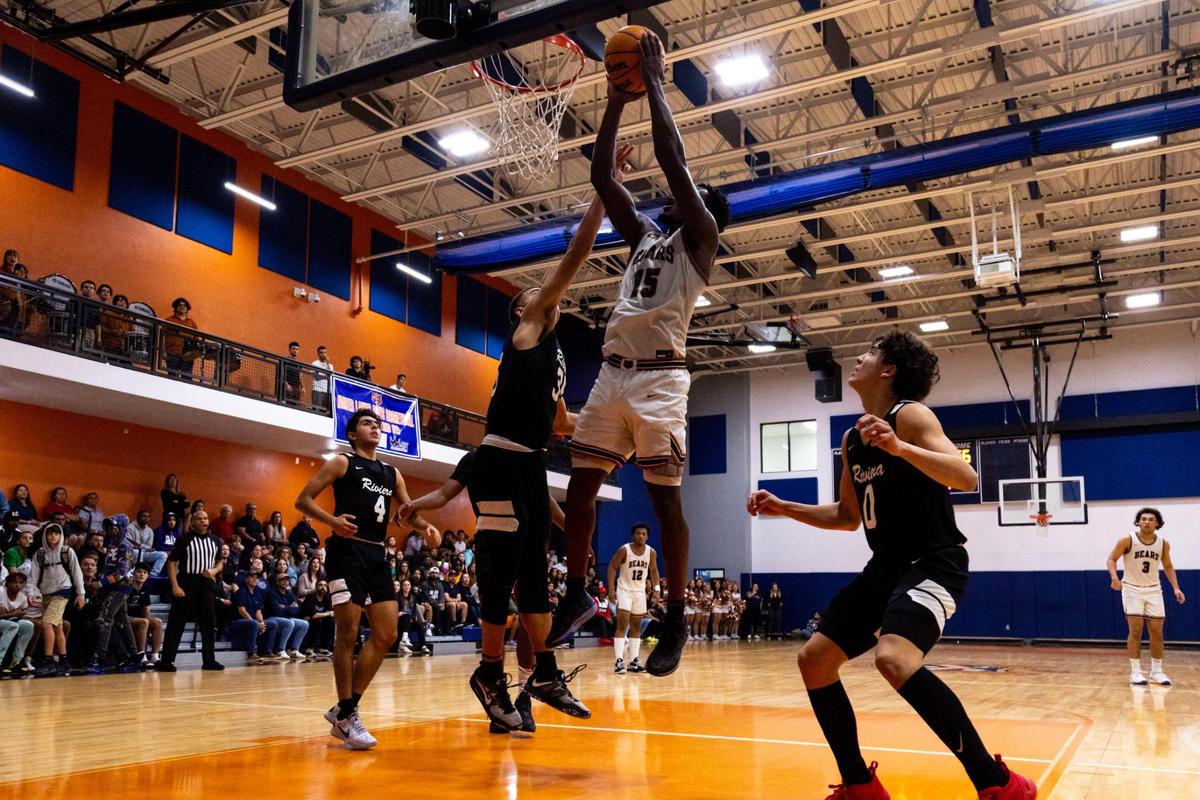 Mater Lakes forward Christian Reid (15) lays up the ball over Riviera Prep forward Dante Allen (35) during a high school basketball game at Mater Lakes High School in Hialeah, Florida, on Wednesday, January 18, 2023.