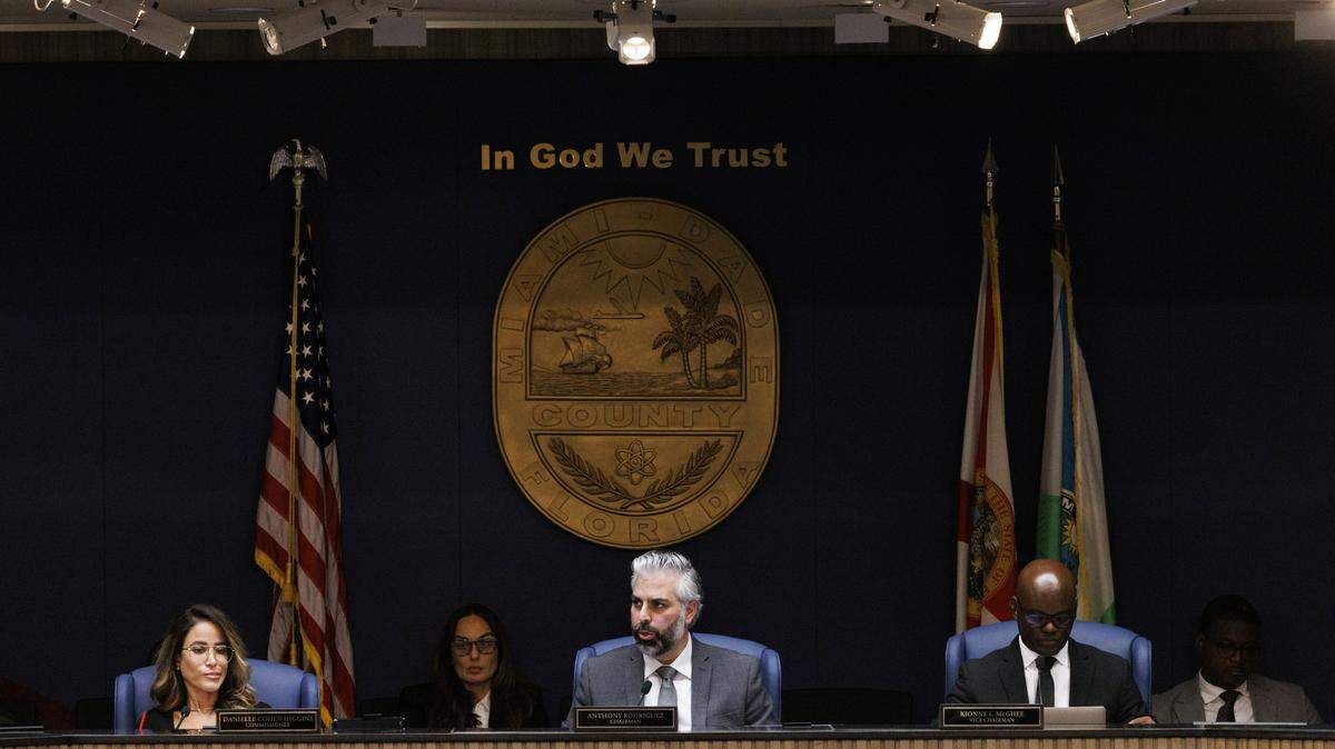 Chairman Anthony Rodriguez, center, speaks while Commissioner Danielle Cohen Higgins, left, Vice Chairman Kionne McGhee, and other commissioners listen during a Miami-Dade County Commission meeting where they voted on the appointment of State Rep. Vicki Lopez to the open District 5 seat commission on Tuesday, Nov. 18, 2025, at the Stephen P Clark Center in downtown Miami, Fla.