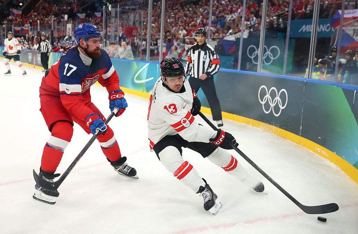 MILAN, ITALY - FEBRUARY 12: Sam Reinhart #13 of Team Canada controls the puck against Filip Hronek #17 of Team Czechia in the first period during the Men's Preliminary Group A match between Czechia and Canada on day six of the Milano Cortina 2026 Winter Olympic games at Milano Rho Ice Hockey Arena on February 12, 2026 in Milan, Italy. (Photo by Gregory Shamus/Getty Images)
