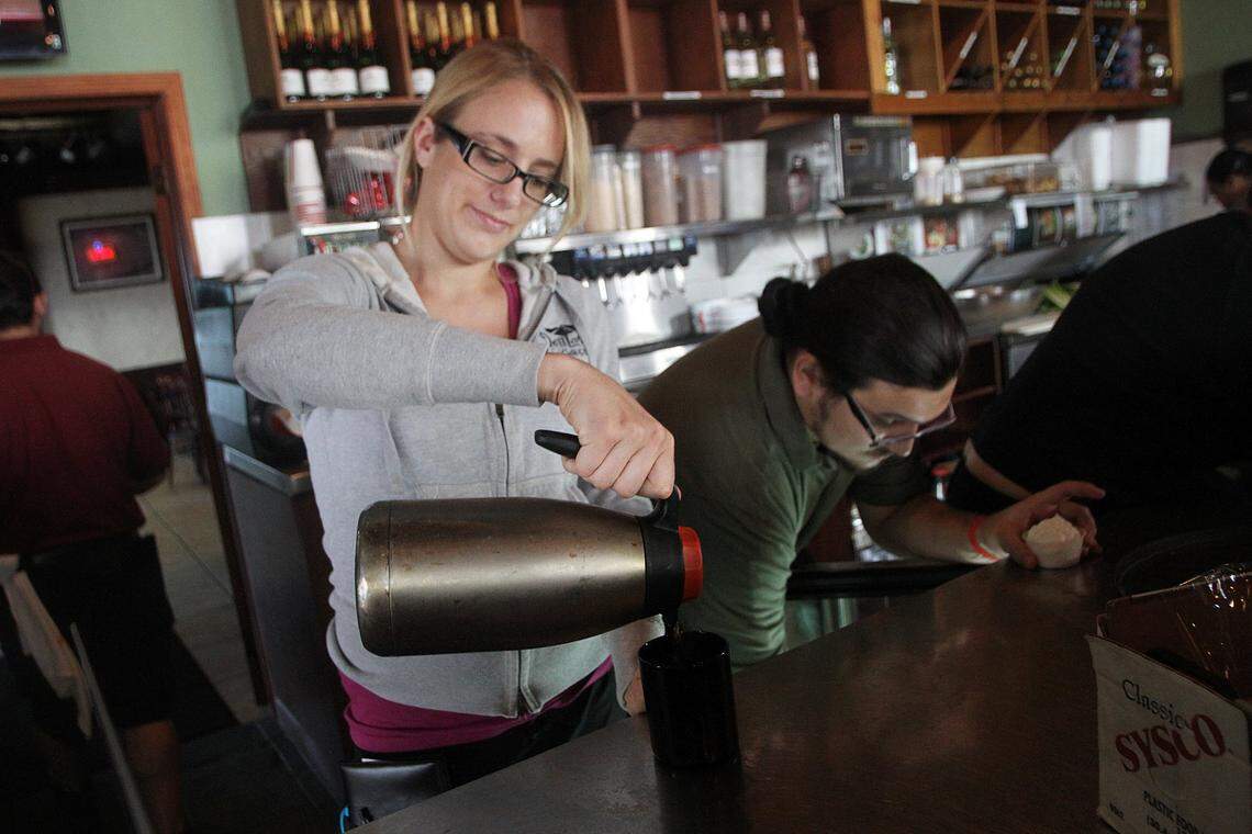 Deli Lane fans may be happy to learn the restaurant will stay in the community, relocating to a new site. Above: Nicole Beck pours a cup of coffee for a customer at Deli Lane Cafe and Tavern in South Miami on Saturday, Dec. 7, 2013.
