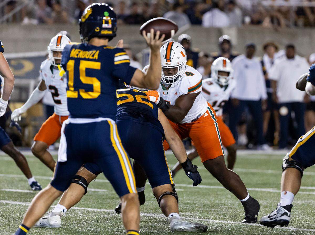 Miami Hurricanes defensive lineman Rueben Bain Jr. (4) works to make his way past California Golden Bears offensive lineman Nick Morrow (52) in the first half of their NCAA college football game at the California Memorial Stadium on Saturday, Oct. 5, 2024, in Berkeley, Calif.