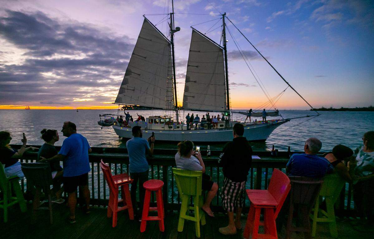A sailboat makes its way past Sunset Pier in Key West, Florida on Sunday, December 12, 2021.