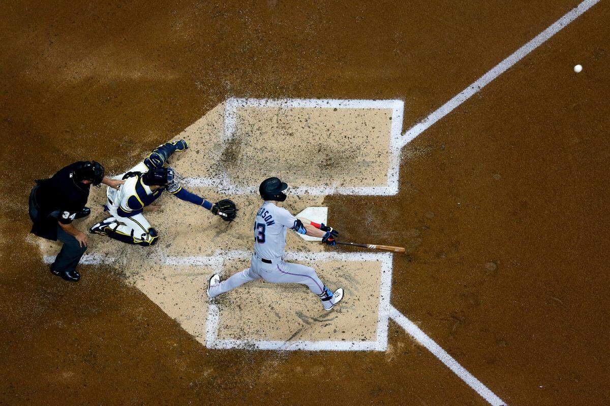 Miami Marlins’ Corey Dickerson hits an RBI double during the fourth inning of a baseball game against the Milwaukee Brewers Monday, April 26, 2021, in Milwaukee.