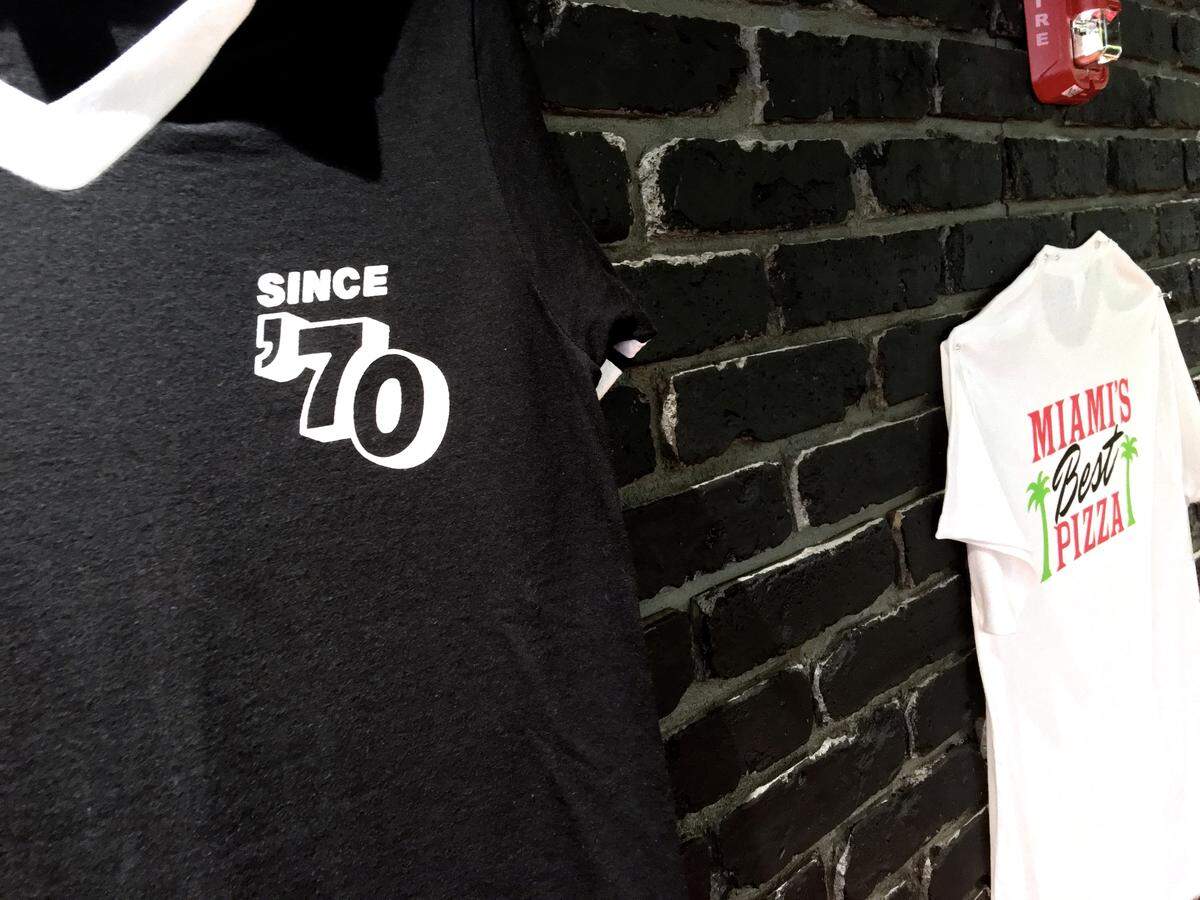 T-shirts with the Miami’s Best Pizza logo are hung on the walls of the current Ponce de Leon Boulevard location in Coral Gables in this June 16, 2018 photo.