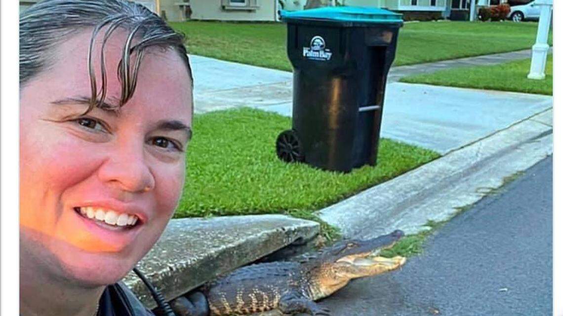 Palm Bay Police Department cop poses with gator/Twitter