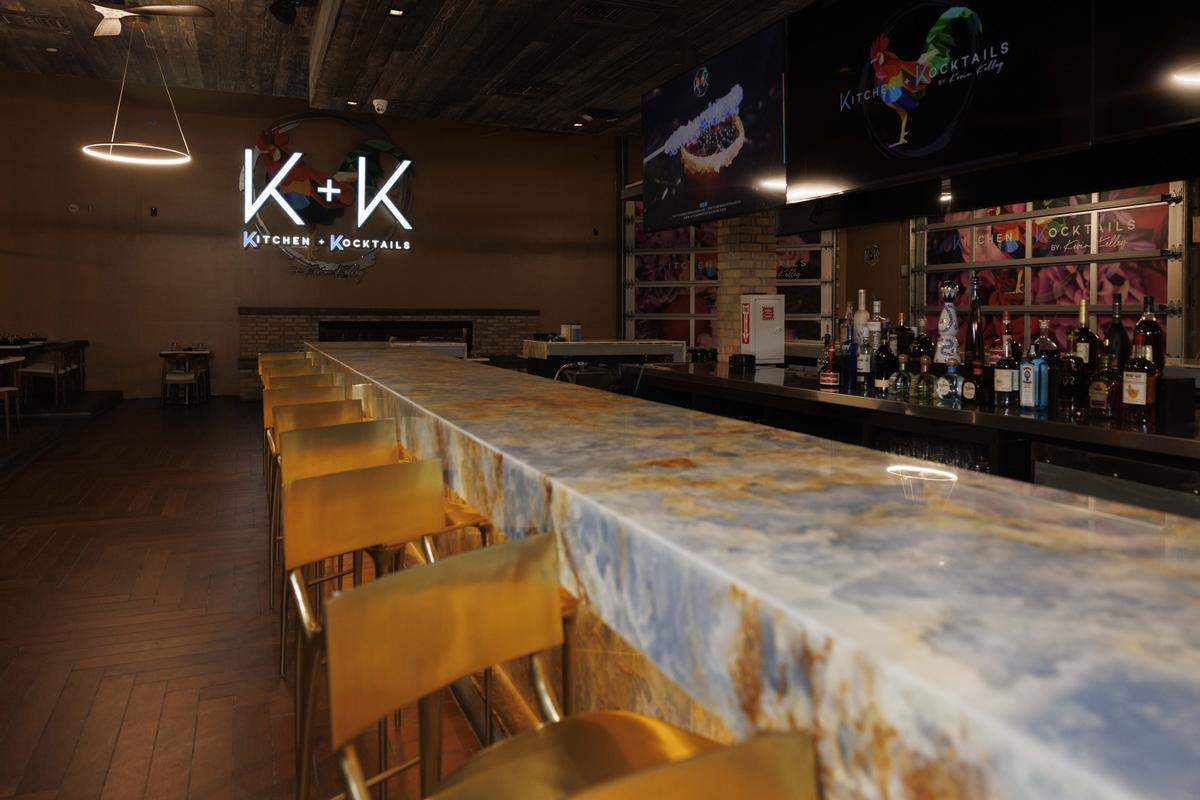 The blue onyx bar, a signature design element, in the huge main dining room of Kitchen + Kocktails in Wynwood.
