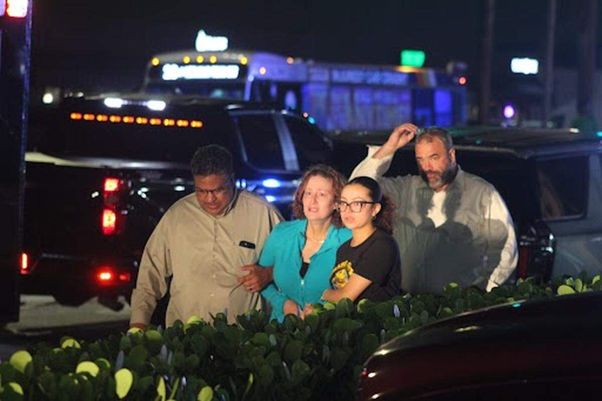 A man gunned down a woman and two children, injuring another, before shooting himself Wednesday night at an apartment near Hallandale Beach. An unidentified woman (center left, wearing a teal shirt) ran onto the crime scene screaming, “That’s my daughter.”