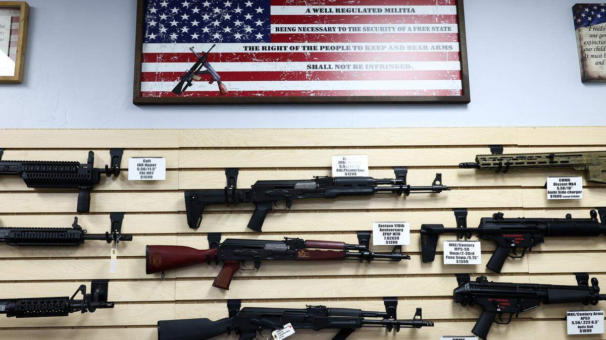 The Second Amendment is spelled on a US flag above a display of firearms for sale in a gun store in Rio Rico, Santa Cruz County, Arizona on September 17, 2025. 