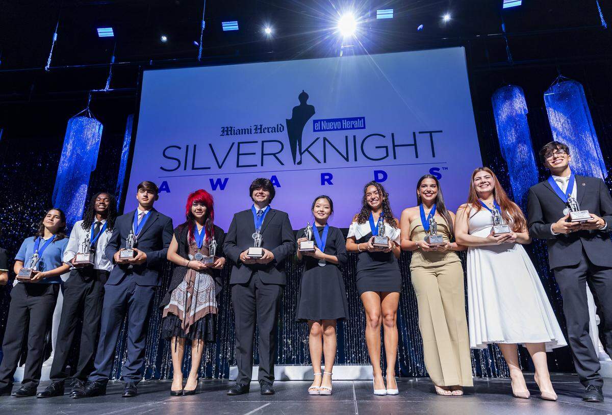 Silver Knight Award winners celebrate on stage after receiving their awards.