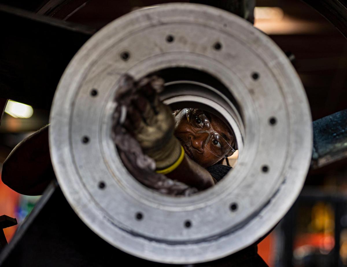 Kamal Muhammad, a welder assembler, works on a pump at MWI in Deerfield Beach. The pump business is booming, in large part because of increasing flood threats and projections of sea rise in the future.