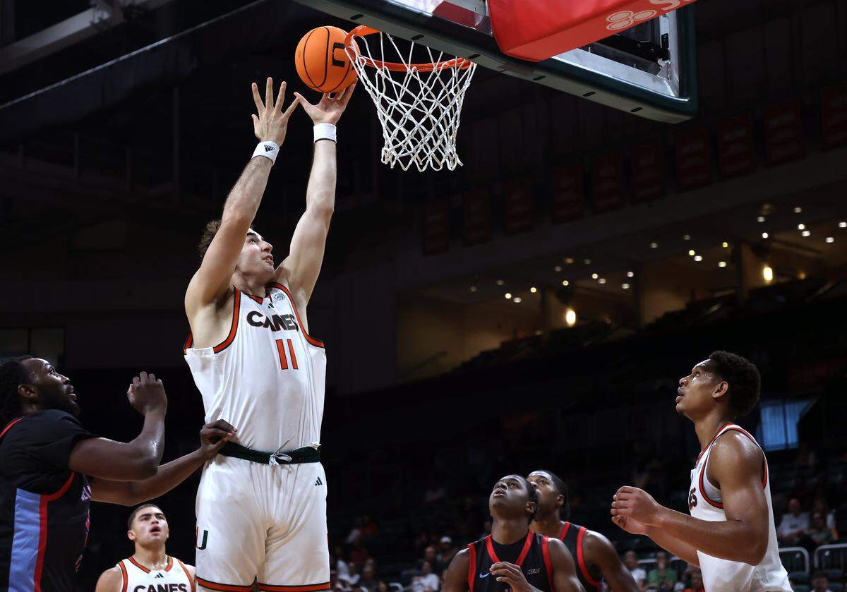 Miami Hurricanes center Salih Altuntas (11), center, scores in the paint as Miami Hurricanes (4-1) played against Delaware State Hornets in the first half at the Watsco Center in Coral Gables, on Sunday, November 23, 2025.