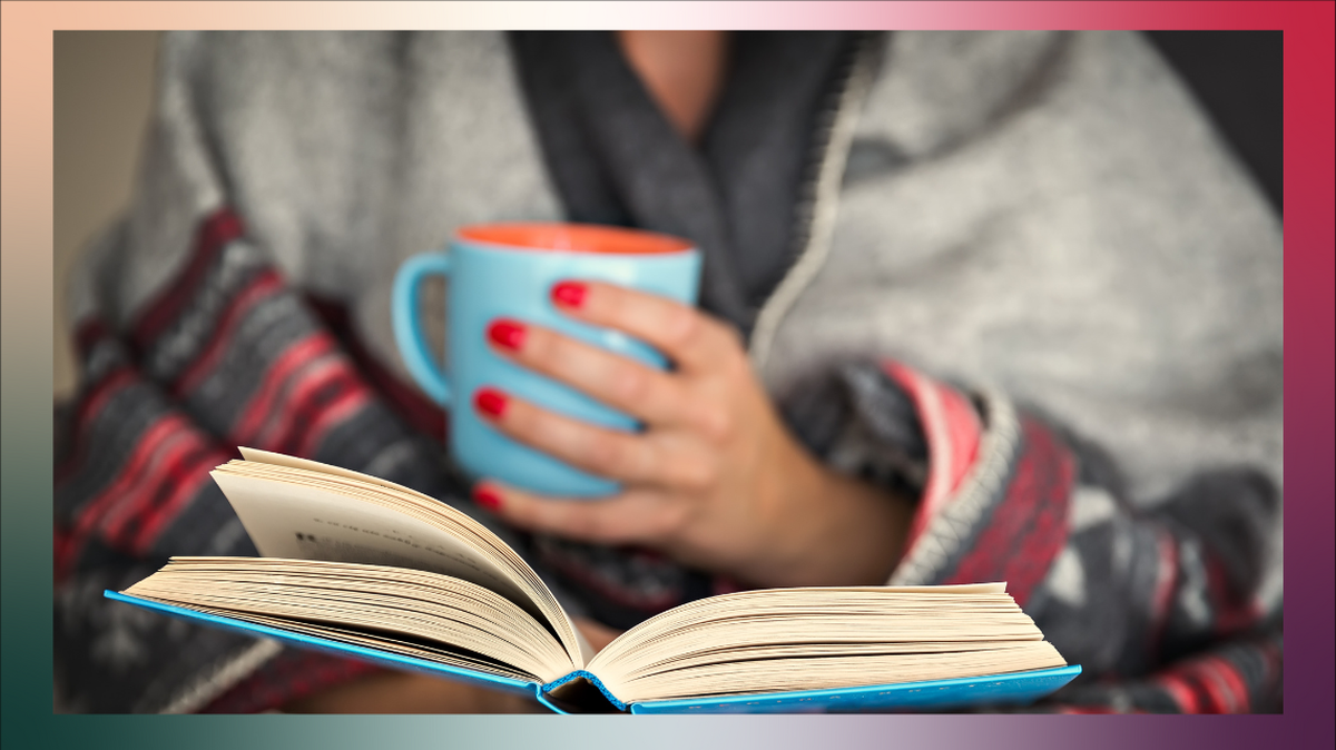 Reading a book with a coffee cup. 