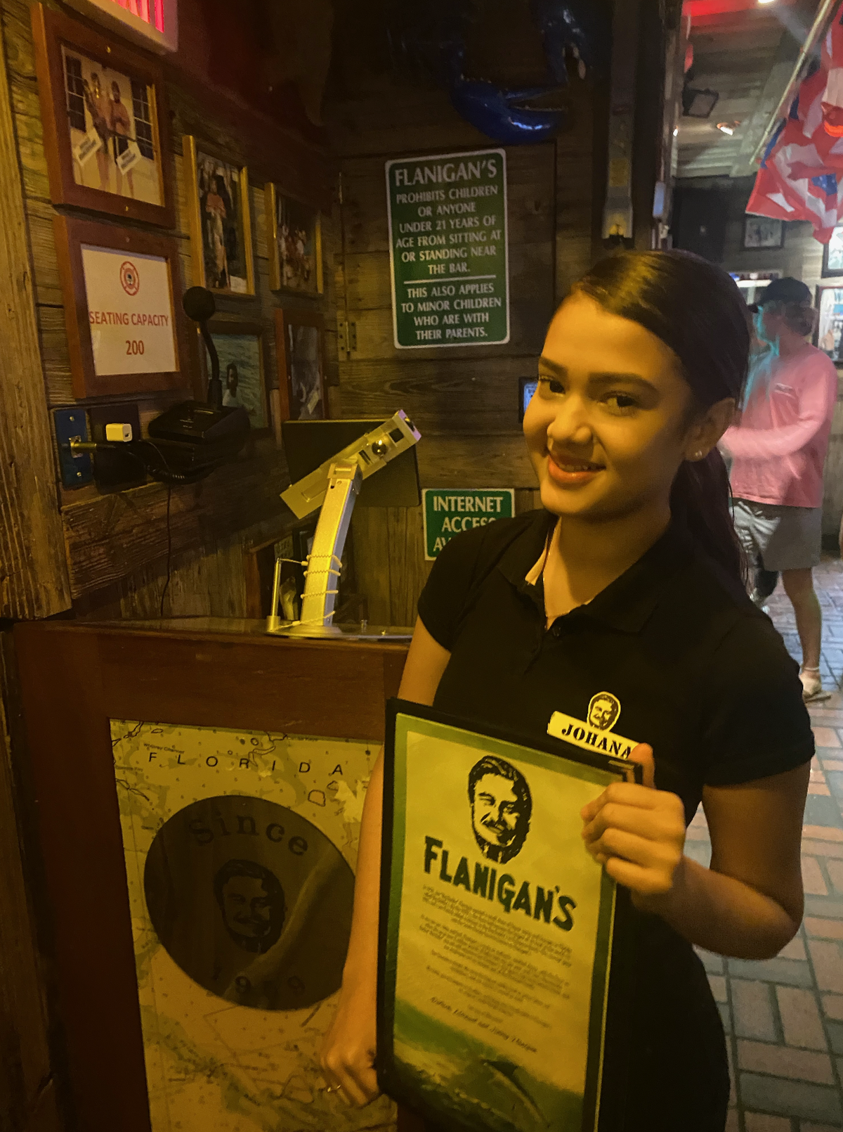 Johana Arana, 16, is working as a host at Flanigan’s in Coconut Grove this summer. Flanigan’s recently put up billboards along I-95 in Miami-Dade and Broward advertising for help wanted.
