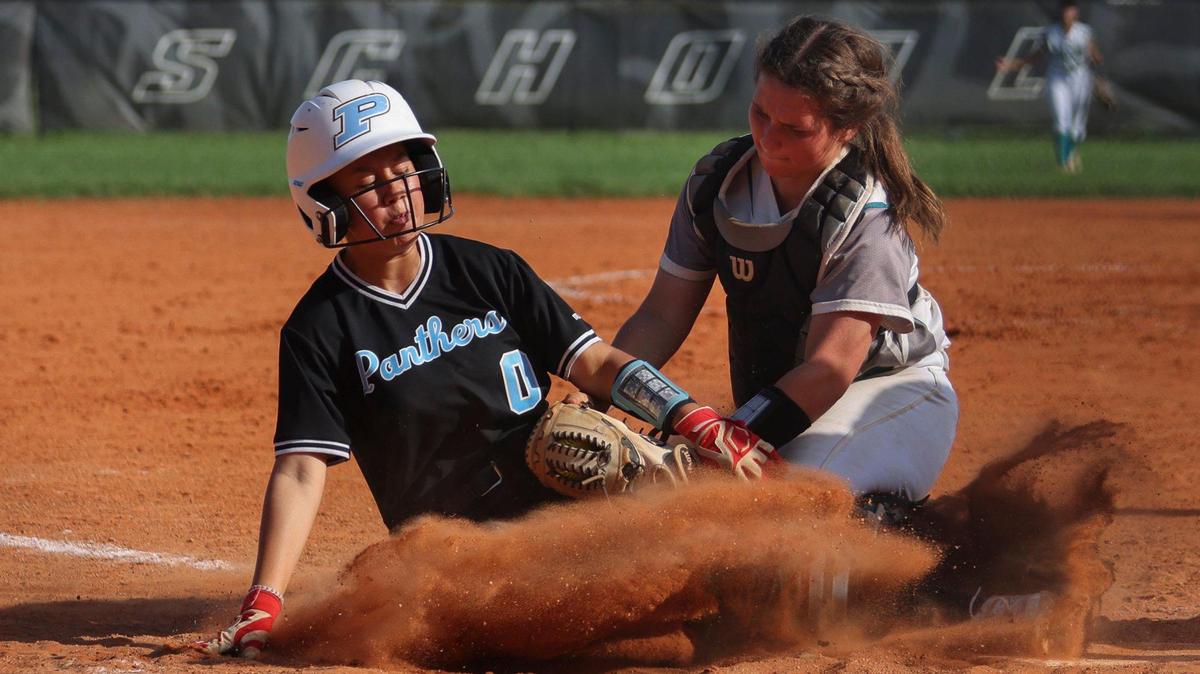 Coral Reef’s catcher Charlotte Diedrick (10) tags Palmetto’s Gracie Silberberg (0) out at home plate during the seventh inning of the Greater Miami Athletic Conference softball final on Thursday, April 20, 2023, at Coral Reef High School in Richmond Heights, Fla. Coral Reef won 5-2.