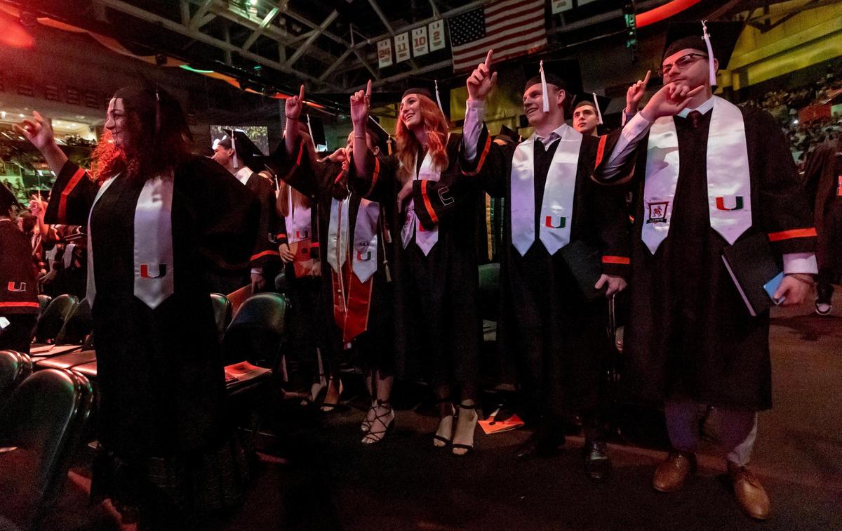 Graduates sing their alma matter, “Stand Forever,” at UM’s spring commencement ceremony Friday morning, the first for the undergraduate students.
