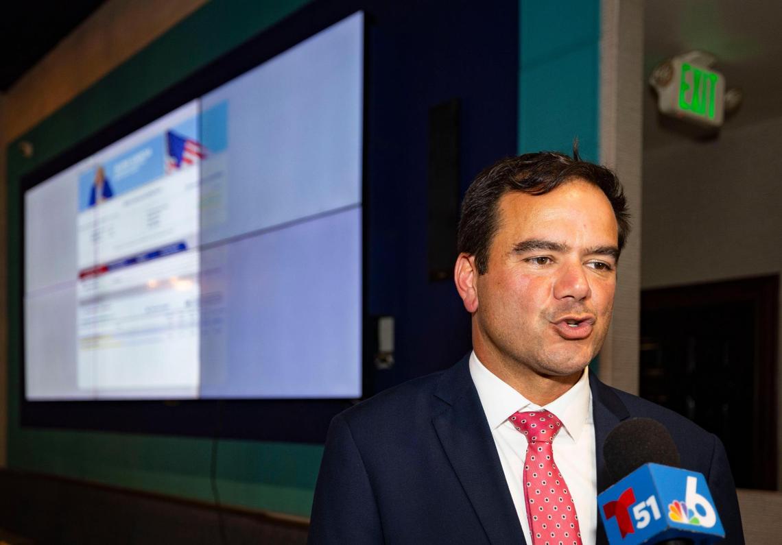 Ralph Rosado is interviewed by the press with the election results in the background during his watch party on Tuesday, June 3, 2025, at El Atlacatl restaurant in Miami.