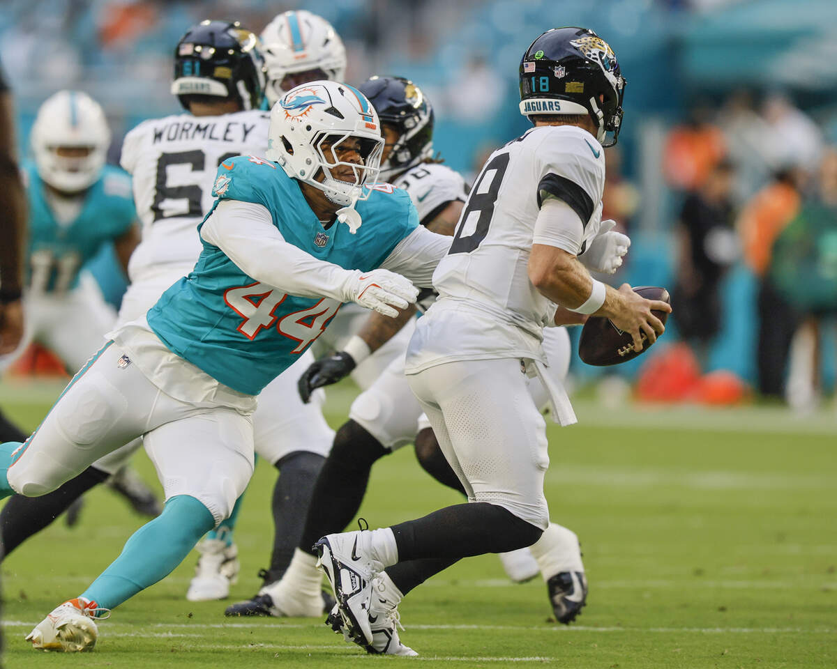 Miami Dolphins linebacker Chop Robinson (44) sacks Jacksonville Jaguars quarterback John Wolford (18) in the first half during an NFL football game at Hard Rock Stadium in Miami Gardens, Florida, on Saturday, August 23, 2025.