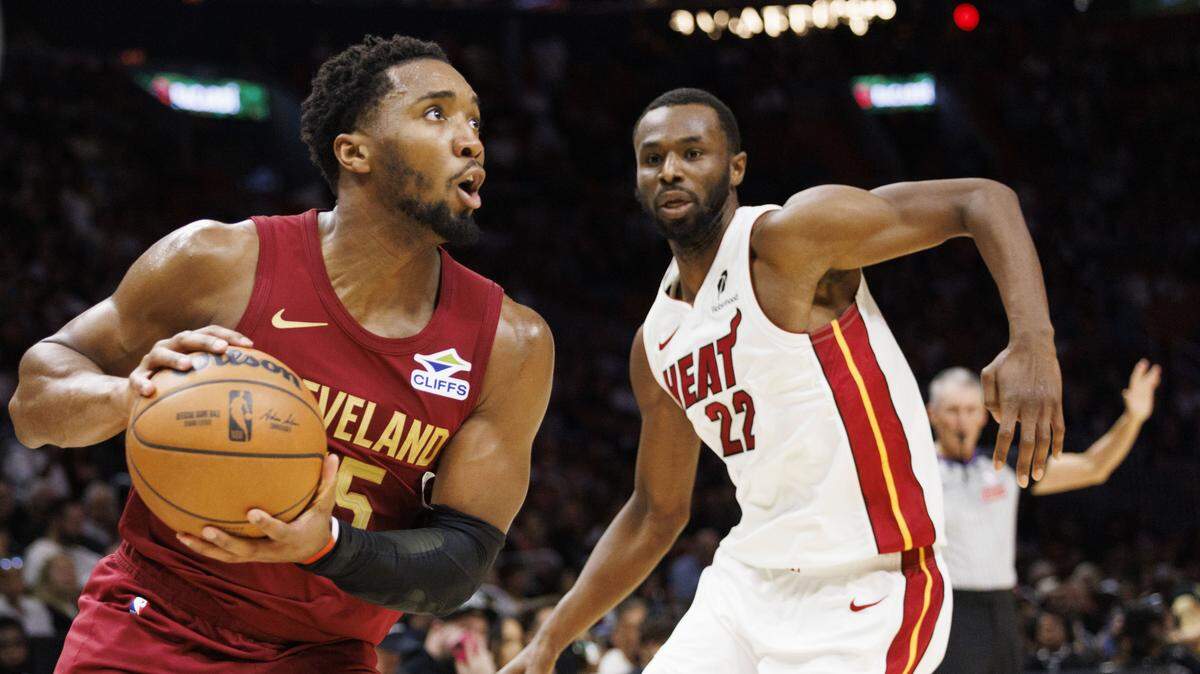 Cleveland Cavaliers guard Donovan Mitchell (45) drives around Miami Heat forward Andrew Wiggins (22) during the first half of a game on Nov. 10, 2025, at Kaseya Center in Miami.