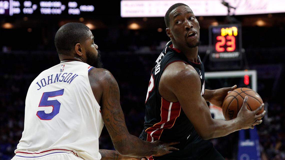 Miami Heat's Bam Adebayo, right, in action against Philadelphia 76ers' Amir Johnson, left, during the first half in Game 1 Saturday's 130-103 loss in the first round of their playoff series.