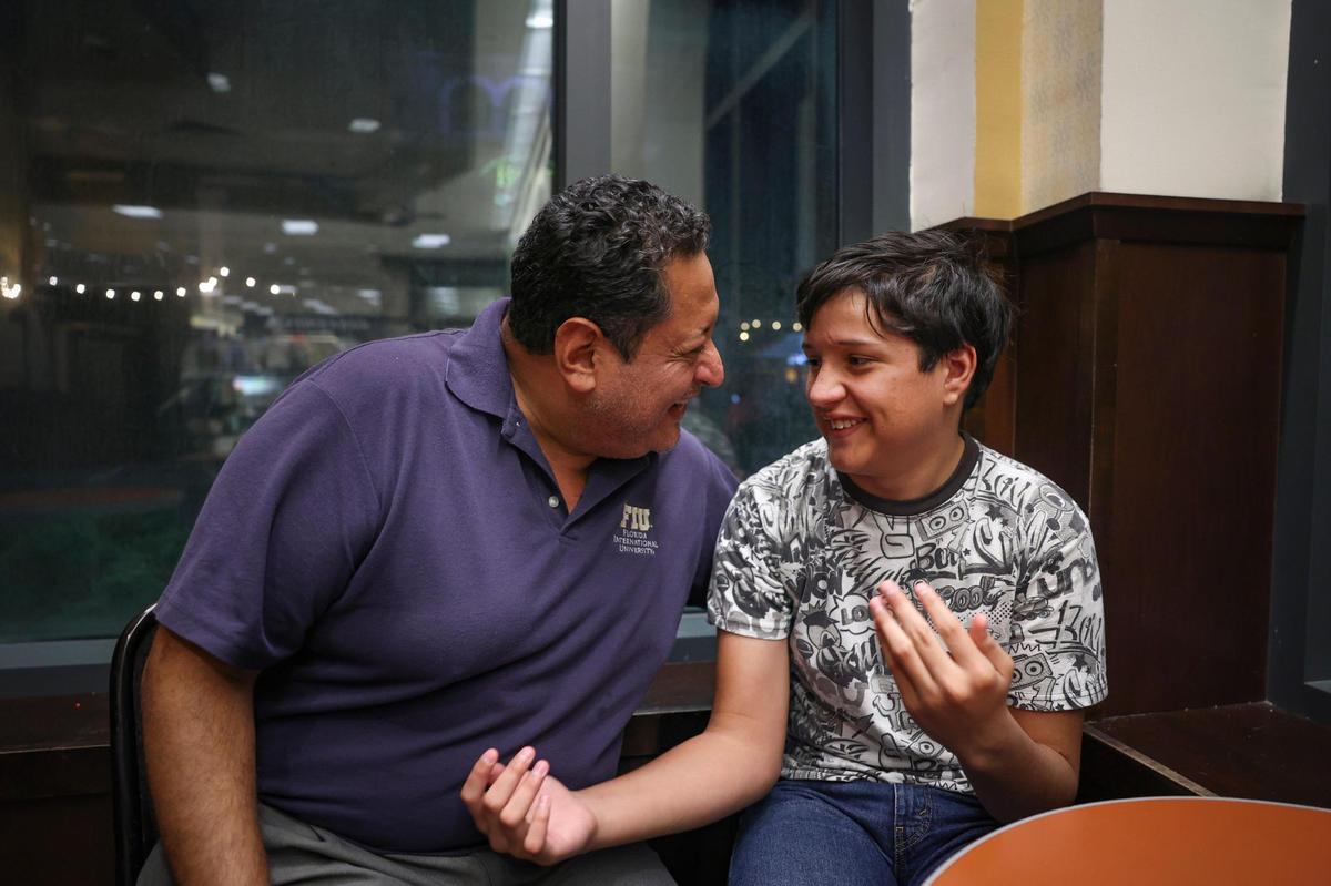 Adrian Gutierrez-Elbers, right, sits with his father, Danilo, in a bookstore in Pembroke Pines on Monday, Dec. 6, 2022. He has a learning disability that affects his reading comprehension, so he is asking for a private tutor to help increase his reading level. He also enjoys researching marine biology and would love to get SCUBA certified so he can advance his interest in marine life.