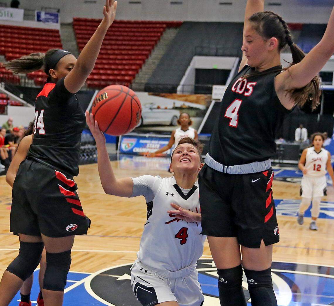 SLAM Marta Franco (4) looks to the basket as she is guarded by Carrollwood Day Ary Dizon (4) in the 4A Semi-Finals Girl’s State Basketball Championships at the RP Funding Center in Lakeland, Florida, Wednesday, February, 27, 2019.