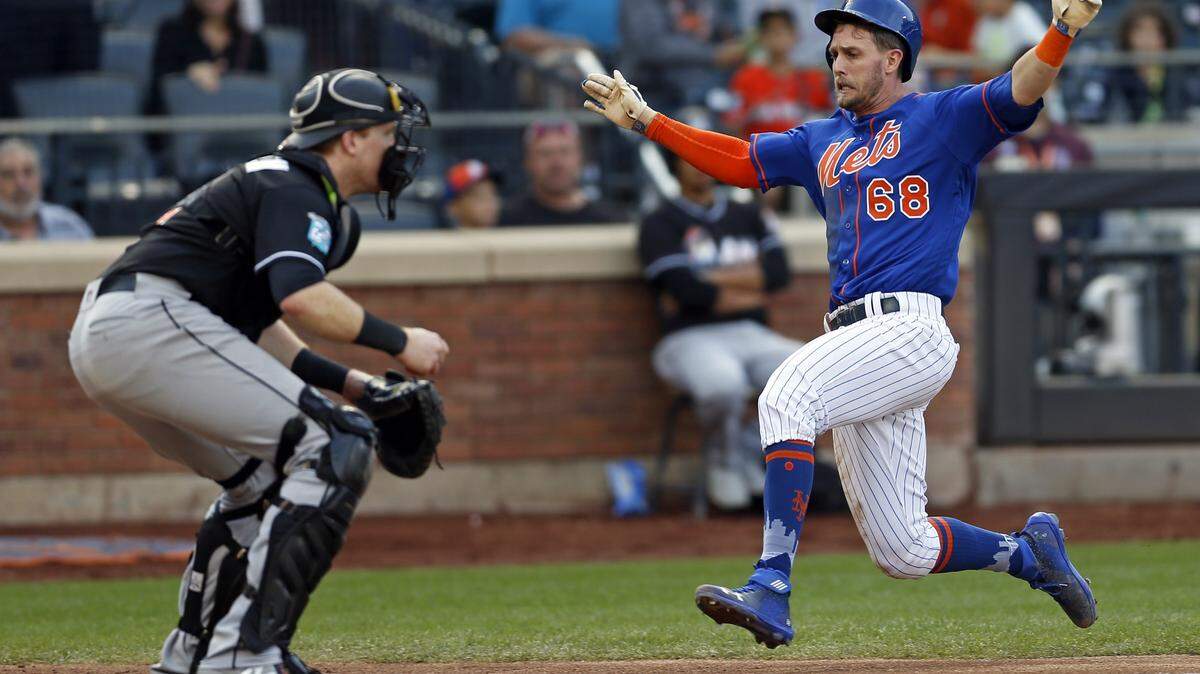 NEW YORK, NY - SEPTEMBER 30: Jeff McNeil #68 of the New York Mets scores a run past Chad Wallach #17 of the Miami Marlins during the fourth inning at Citi Field on September 30, 2018 in the Flushing neighborhood of the Queens borough of New York City. (Photo by Adam Hunger/Getty Images)
