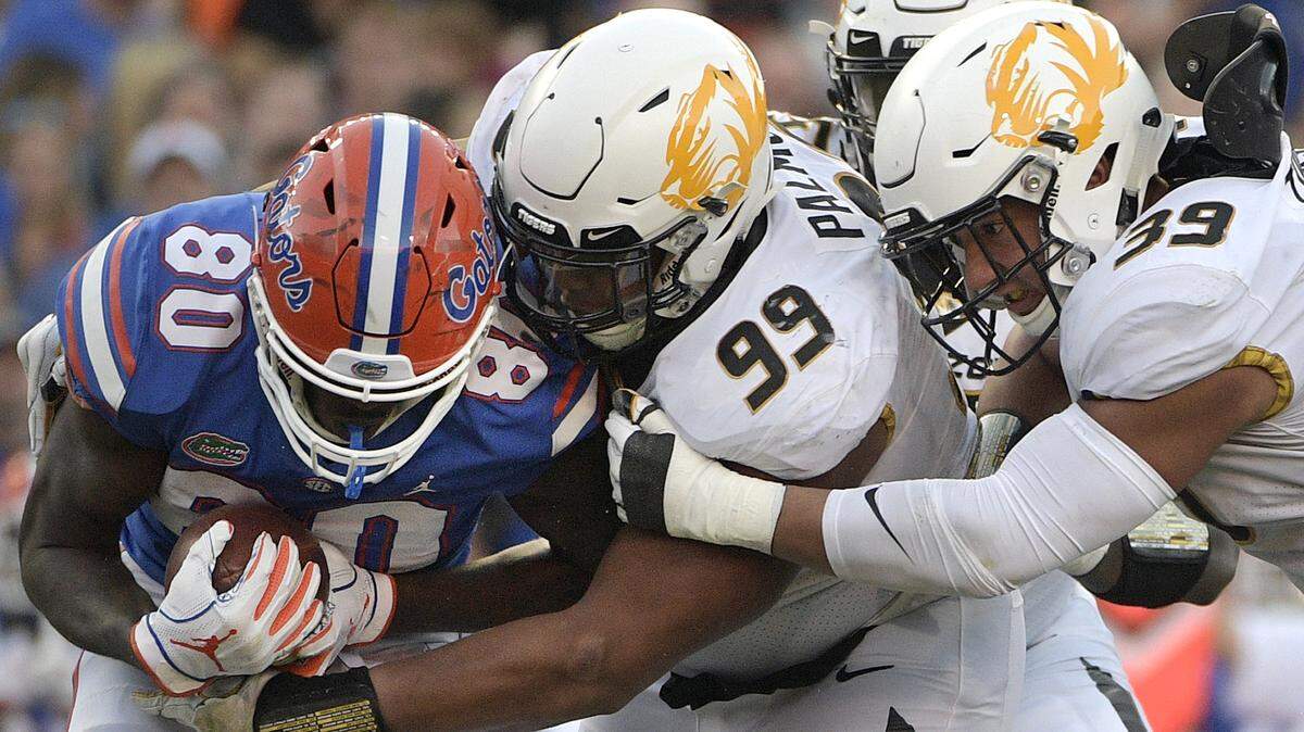 Florida tight end C’yontai Lewis (80) is stopped for a loss by Missouri defensive lineman Walter Palmore.