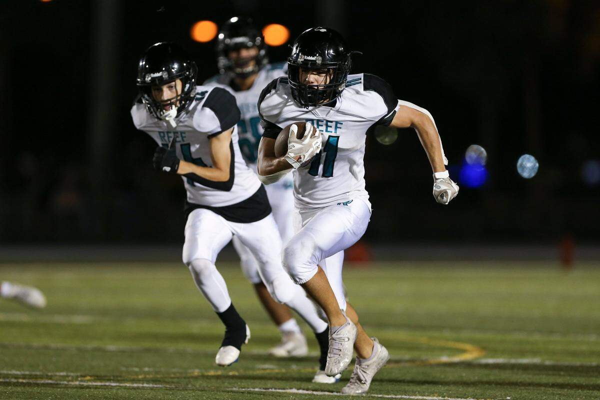 Coral Reef Barracudas wide receiver Nicholas Lardizabal (11) runs with the football for a touchdown during the second quarter of the GMAC Independent Championship game against the Braddock Bulldogs at Tropical Park Stadium in Miami, Florida, Friday, November 11, 2022.