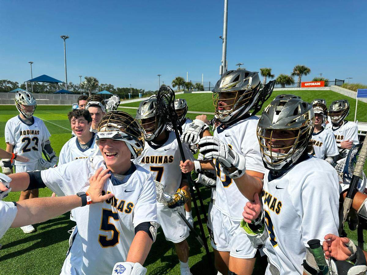 St. Thomas Aquinas’ boys’ lacrosse players celebrate following a 15-6 win over Winter Park on Thursday afternoon in a Class 2A state semifinal at Paradise Coast Sports Complex in Naples, Fla.