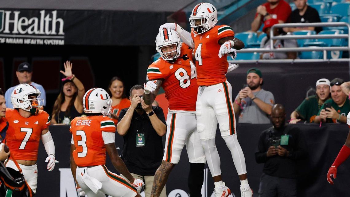 Miami Hurricanes wide receiver Colbie Young (4) with tight end Cam McCormick (84) wide receivers Jacolby George (3) and Xavier Restrepo (7) after scoring against Miami of Ohio Redhawks in the first quarter in Miami Gardens, Florida on Friday, September 1, 2023.