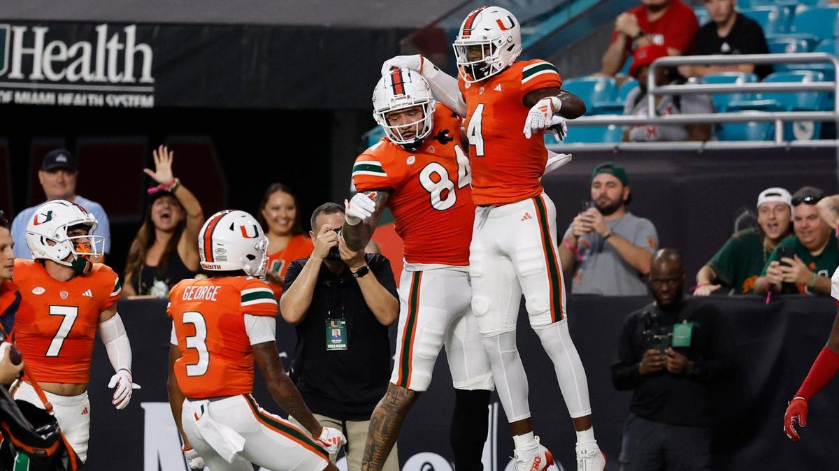 Miami Hurricanes wide receiver Colbie Young (4) with tight end Cam McCormick (84) wide receivers Jacolby George (3) and Xavier Restrepo (7) after scoring against Miami of Ohio Redhawks in the first quarter in Miami Gardens, Florida on Friday, September 1, 2023.