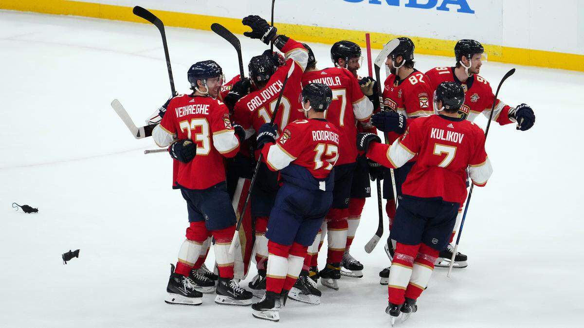 Jan 11, 2024; Sunrise, Florida, USA; Florida Panthers teammates celebrate after defeating the Los Angeles Kings in overtime at Amerant Bank Arena.