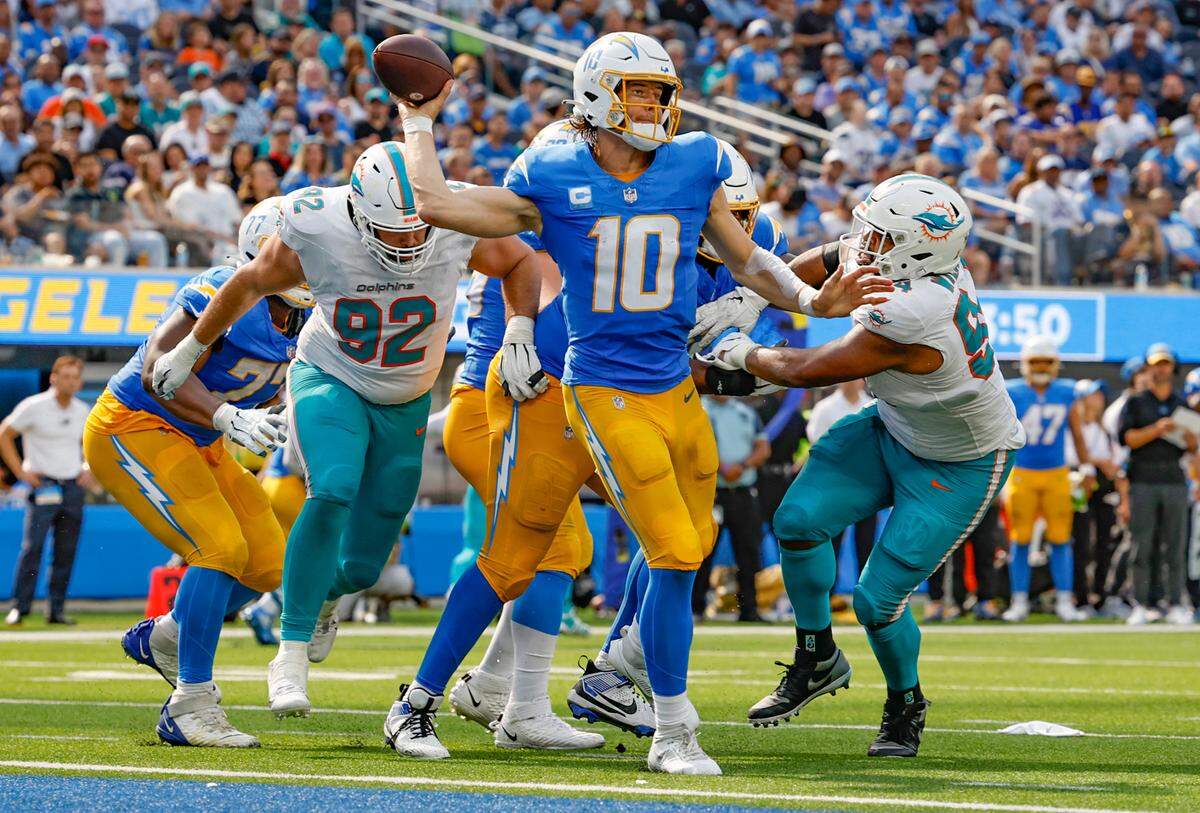 Miami Dolphins defensive tackles Zach Sieler (92) and Christian Wilkins (94) pressure Los Angeles Chargers quarterback Justin Herbert (10) in the third quarter near the Chargers goal line at SoFi Stadium in Inglewood, California on Sunday, September 10, 2023.