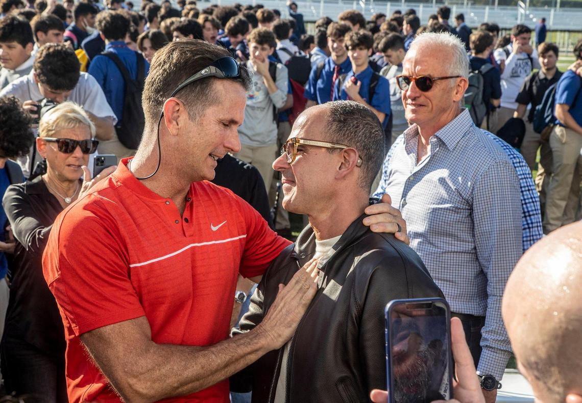 Entrepreneur and TV personality Marcus Lemonis shares a hug with Bill Desmond, whose family was instrumental for Lemonis to attend Christopher Columbus in Miami. He announced at the school on Thursday his donation to build two centers, one of which will be named after the Desmond family.