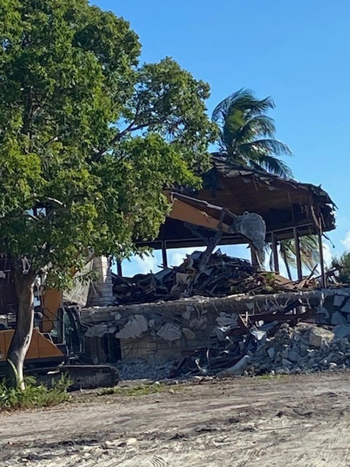 A backhoe tears at a Coral Gables home designed by architect Alfred Browning Parker that was considered a modern design masterwork.