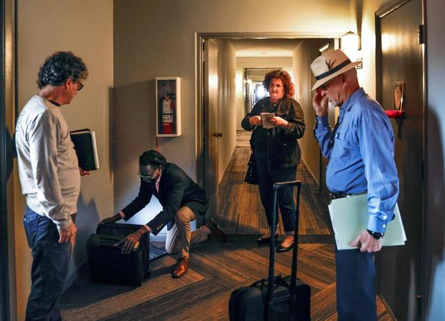 Attorney Brad Schandler, at right, prepares to preside over a foreclosure auction at Oakland Grove Village Condominium in Oakland Park, Florida on Tuesday, February 27, 2024. Auction bidders include Schandler’s sister, Nadine August, seen at center, and Mauricio J. Riquer, at left. They are joined by court reporter Gary Siffort.