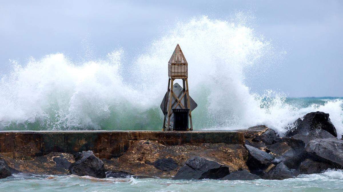 Waves crash against the jetty at the Bal Harbour Lighthouse on April 12, 2023, in Bal Harbour. As Hurricane Lee heads north Wednesday, Sept. 13, 2023, South Florida seas could expect high surf conditions, rip currents and swells, especially in Palm Beach County and north.