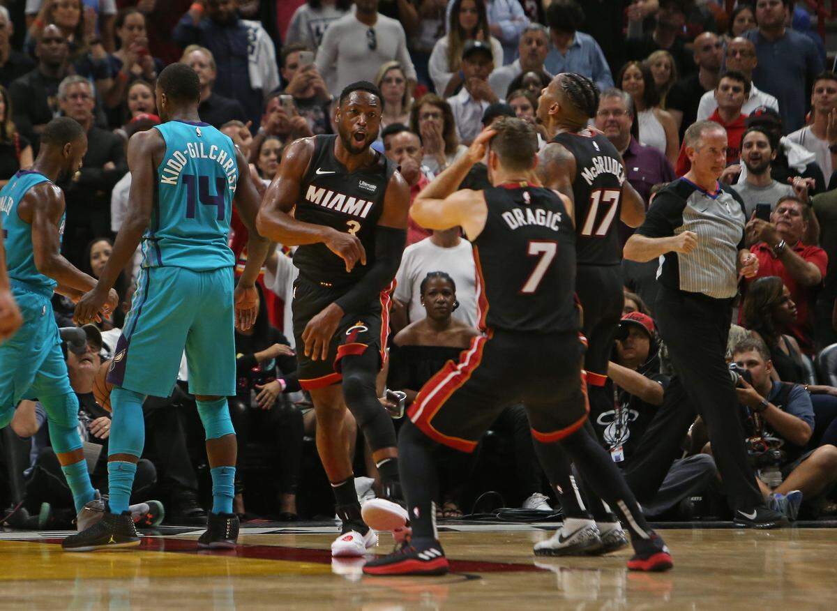 Miami Heat guard Dwyane Wade (3) Rodney McGruder (17) and Goran Dragic (7) reacting after a play in the fourth quarter of an NBA basketball game against the Charlotte Hornets at AmericanAirlines Arena on Saturday, October 20, 2018 in Miami.