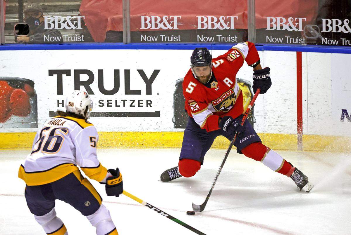 Florida Panthers defenseman Aaron Ekblad (5) carries the puck against Nashville Predators left wing Erik Haula (56) during the first period of their NHL game at the BB&T Center on Thursday, March 18, 2021 in Sunrise, Fl.