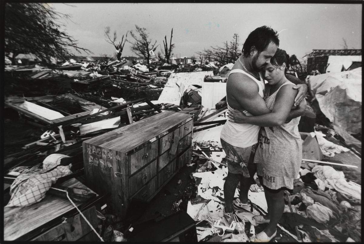 Vivian and Lazaro Hernandez embraced after finding some salvageable memories, like wedding photos in the remains of what was their home in this file photo after Hurricane Andrew hit South Miami-Dade on Aug. 24, 1992.