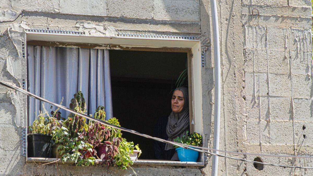 A relative seen in the window mourning during the funeral of two Palestinians who were killed Sunday by Israeli soldiers in the Nour Shams refugee camp.