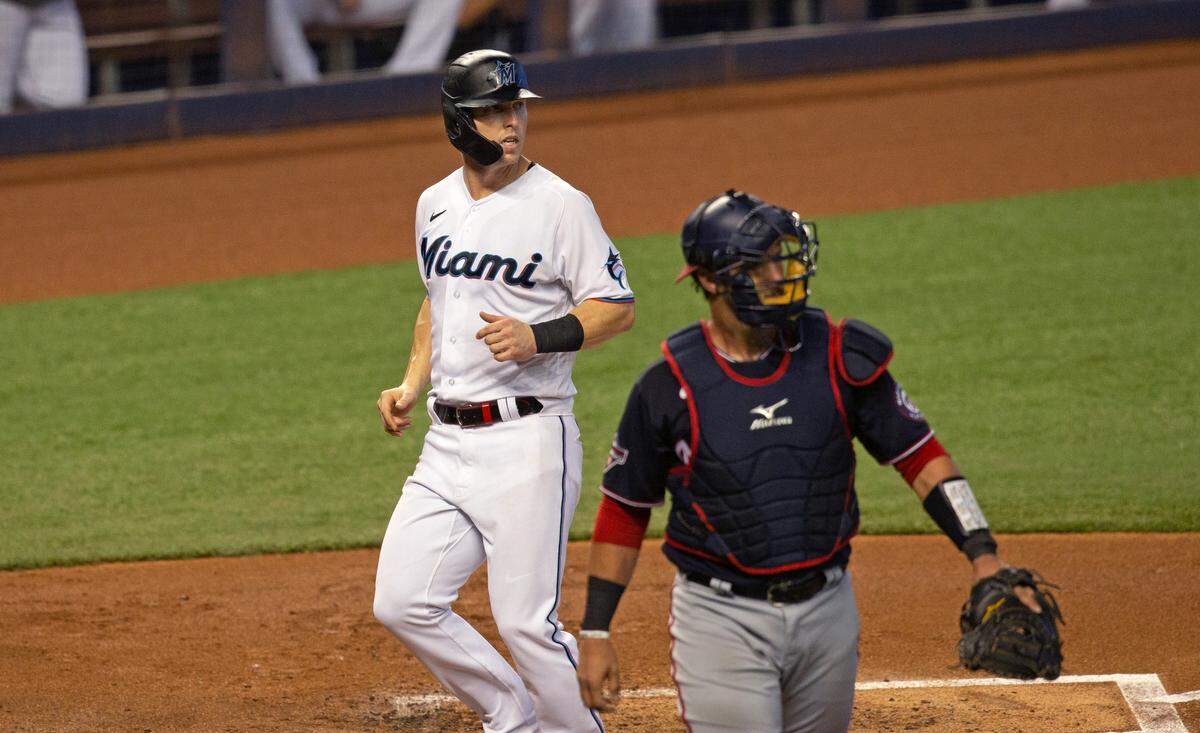 Washington Nationals catcher Yan Gomes (10) looks on as Miami Marlins left fielder Corey Dickerson (23) scores during the first inning of the first game of a baseball doubleheader at Marlins Park in Miami on Sunday, September 20, 2020.
