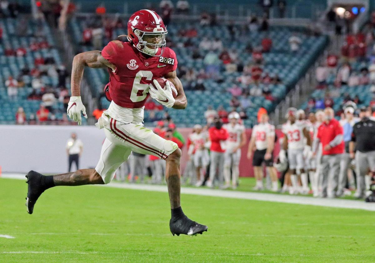 Alabama Crimson Tide wide receiver DeVonta Smith (6) scores in the first half against Ohio State Buckeyes during the 2021 National Championship game at Hard Rock Stadium in Miami Gardens on Monday, January 11, 2021.