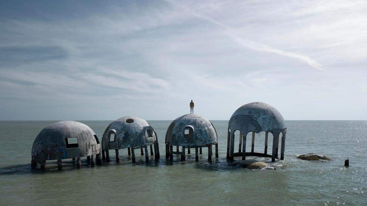 British artist Simon Faithfull stands atop one of the almost-submerged structures of Dome House near Marco Island.
