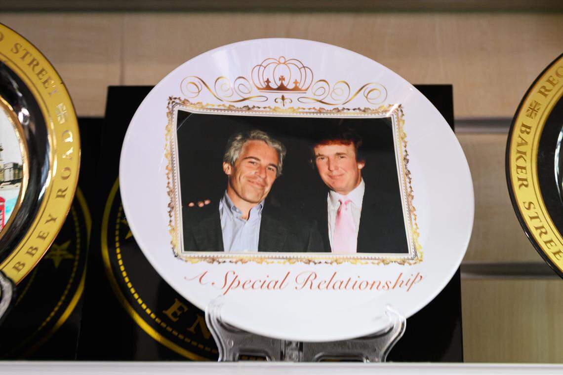 WINDSOR, ENGLAND - SEPTEMBER 12: A satirical commemorative plate made by the group "Everyone Hates Elon" featuring convicted sex trafficker Jeffrey Epstein and US President Donald Trump, reading "A Special Relationship", among gift shop souvenirs in a gift shop in Windsor, England.