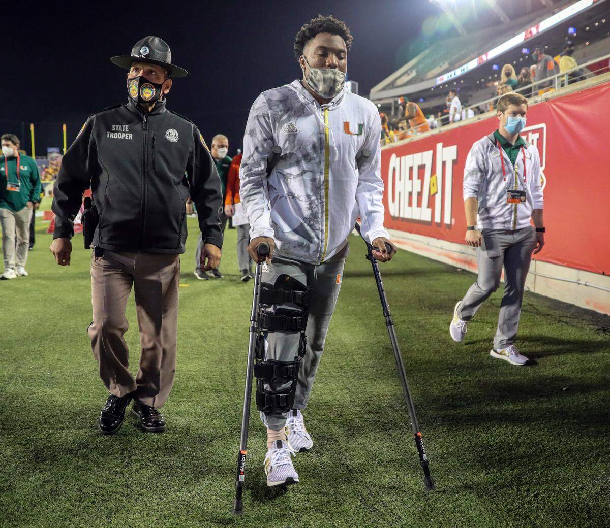 An injured Miami Hurricanes quarterback D’Eriq King (1) walks off the field after UM loses to Oklahoma State Cowboys during the 2020 Cheez-It Bowl at Camping World Stadium in Orlando on Tuesday, December 29, 2020.