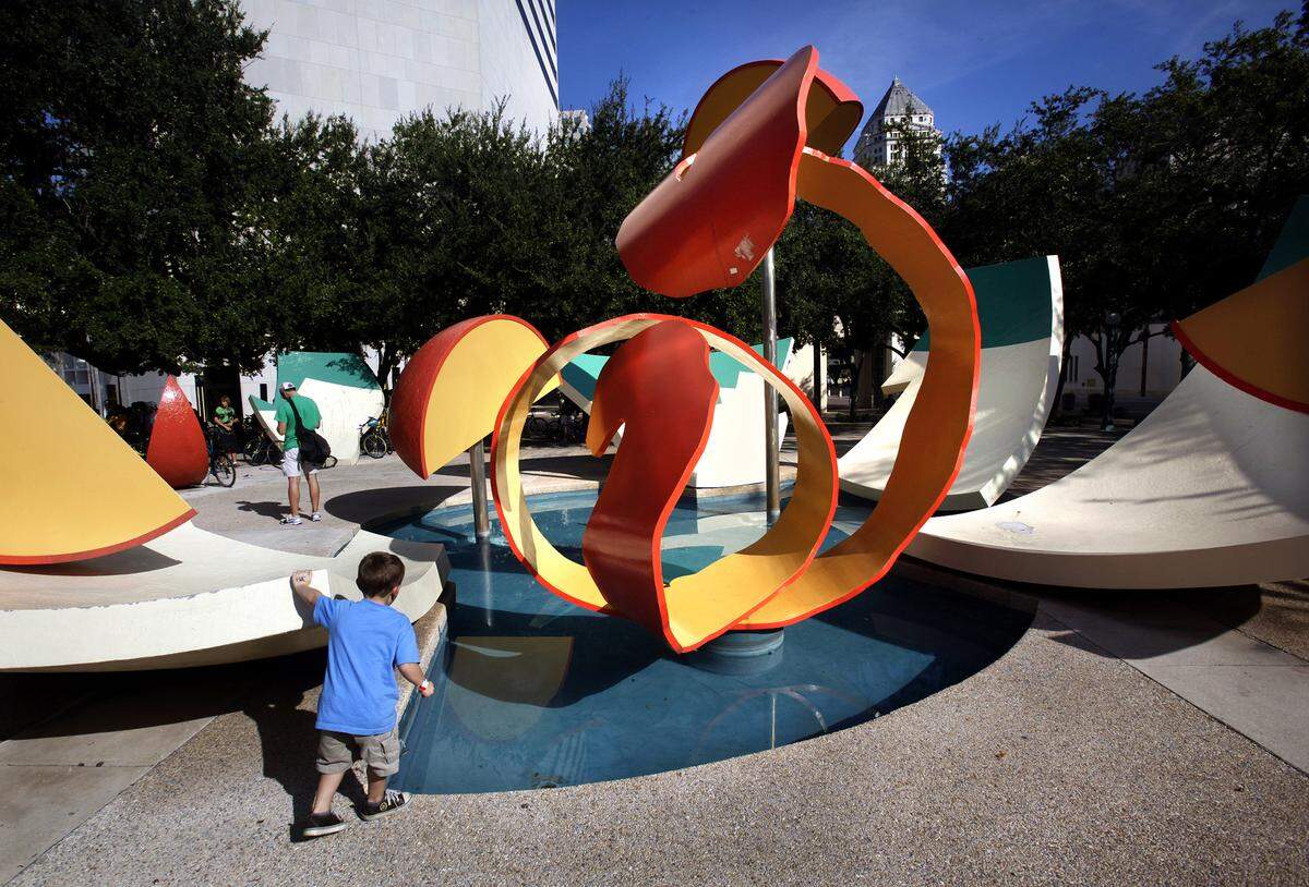 A 4-year-old pauses to look at “Dropped Bowl with Scattered Slices and Peels,” an Art in Public Places sculpture at the Miami-Dade County Government Center in 2010.
